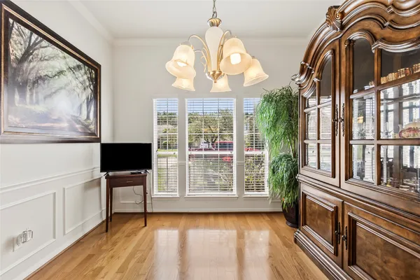 a view of a livingroom with furniture a flat screen tv and wooden floor