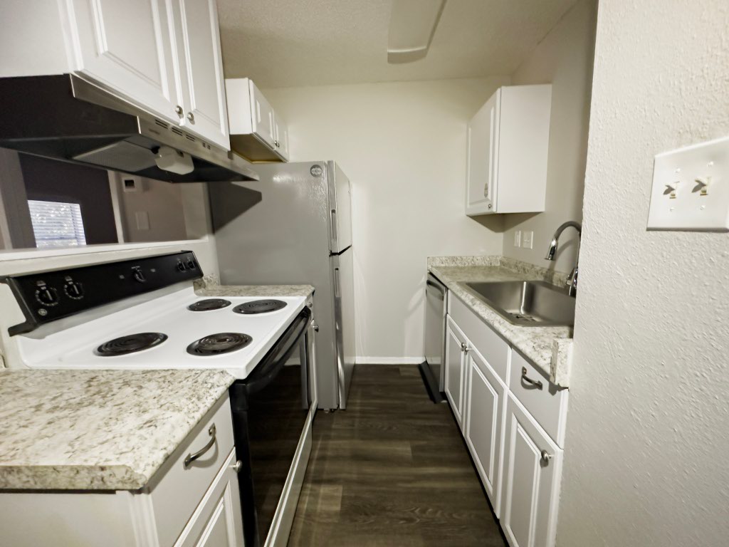 4500 Witham Lane, Unit 104 Austin, TX 78745 - Photo 18 of 27 a kitchen with a stove and a sink