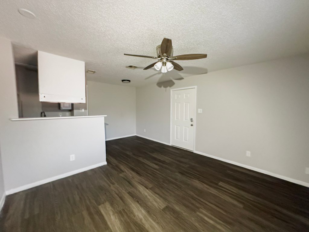 4500 Witham Lane, Unit 104 Austin, TX 78745 - Photo 19 of 27 a view of room with wooden floor and ceiling fan