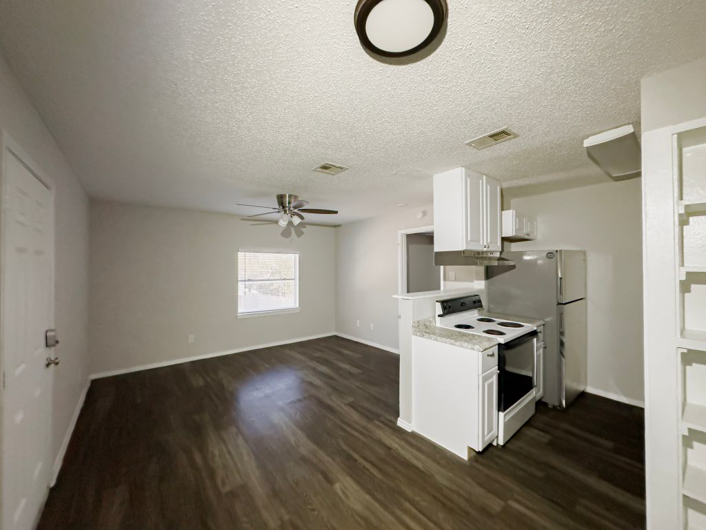 4500 Witham Lane, Unit 104 Austin, TX 78745 - Photo 21 of 27 a kitchen with a stove a refrigerator and a microwave