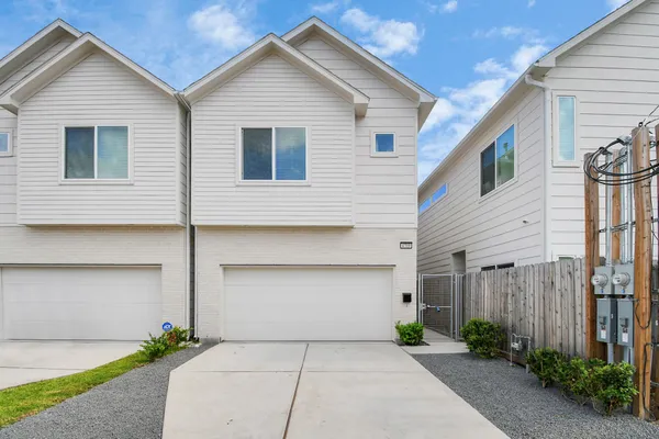 a view of a house with a yard and garage