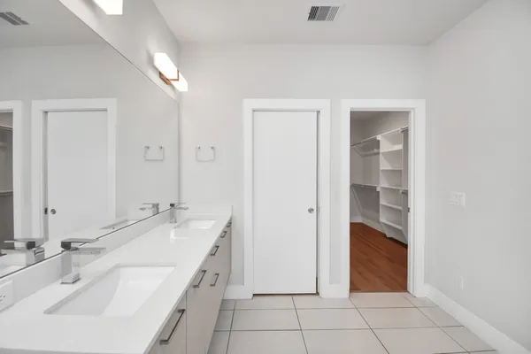 an empty room with wooden floor and ceiling fan