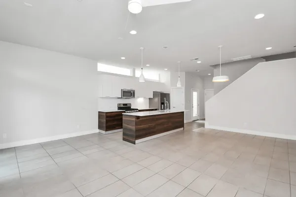 a large white kitchen with a large window