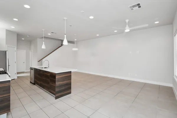 a view of kitchen with kitchen island and a ceiling fan