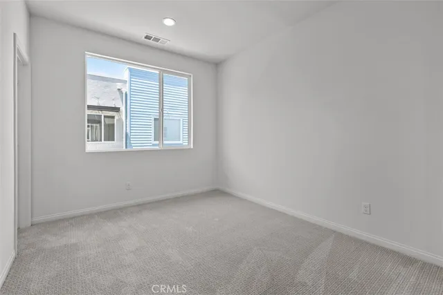 an empty room with a bathroom and a sink