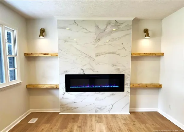 a view of a livingroom with furniture and a fireplace