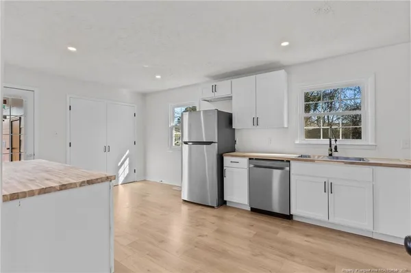 a kitchen with sink cabinets and refrigerator