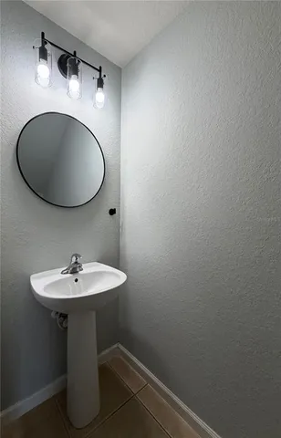 a bathroom with a sink toilet and mirror