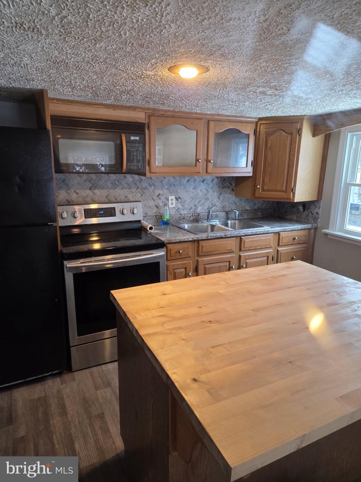 8012 Appleby Road Harrisburg, PA 17112 - Photo 20 of 32 a kitchen with kitchen island granite countertop a stove and a sink