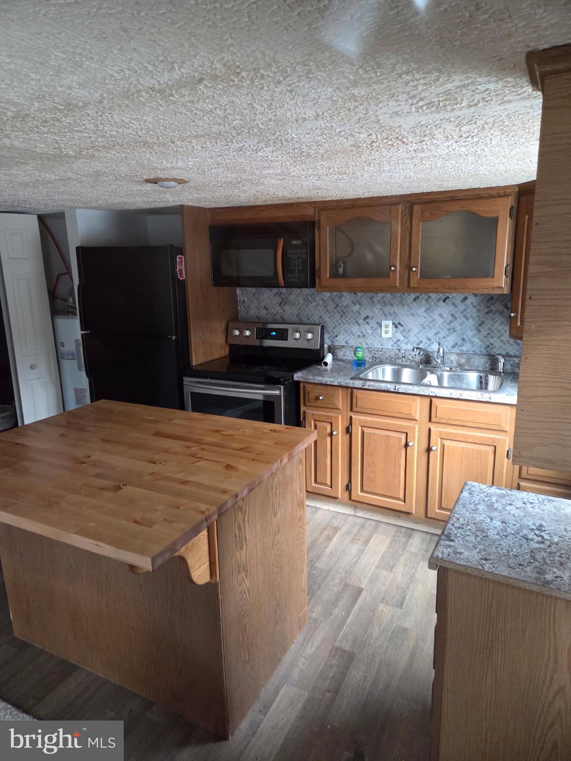 8012 Appleby Road Harrisburg, PA 17112 - Photo 23 of 32 a kitchen with stainless steel appliances a sink a stove top oven a counter space and cabinets