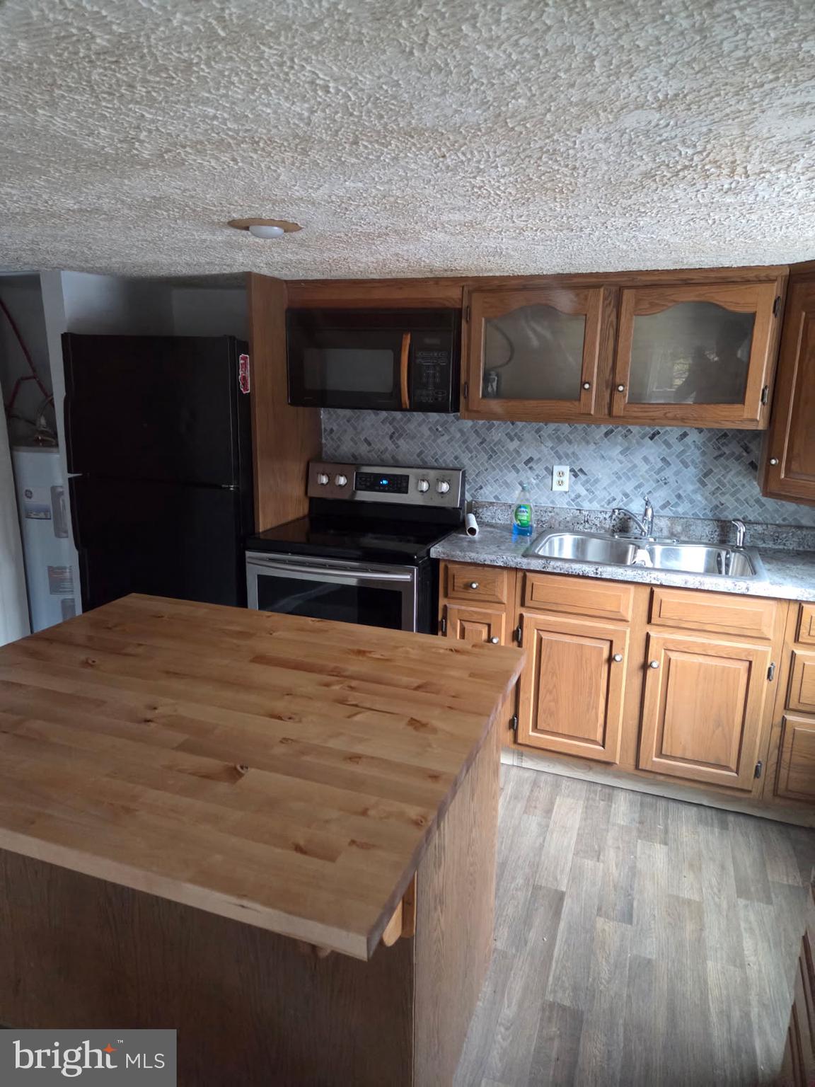 8012 Appleby Road Harrisburg, PA 17112 - Photo 27 of 32 a kitchen with stainless steel appliances kitchen island granite countertop a stove a sink and a microwave
