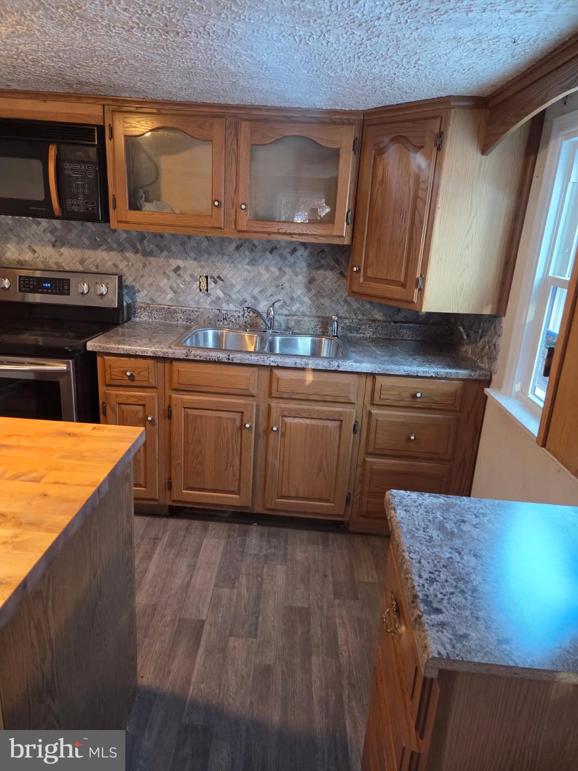 8012 Appleby Road Harrisburg, PA 17112 - Photo 6 of 32 a kitchen with wooden cabinets a sink and a stove