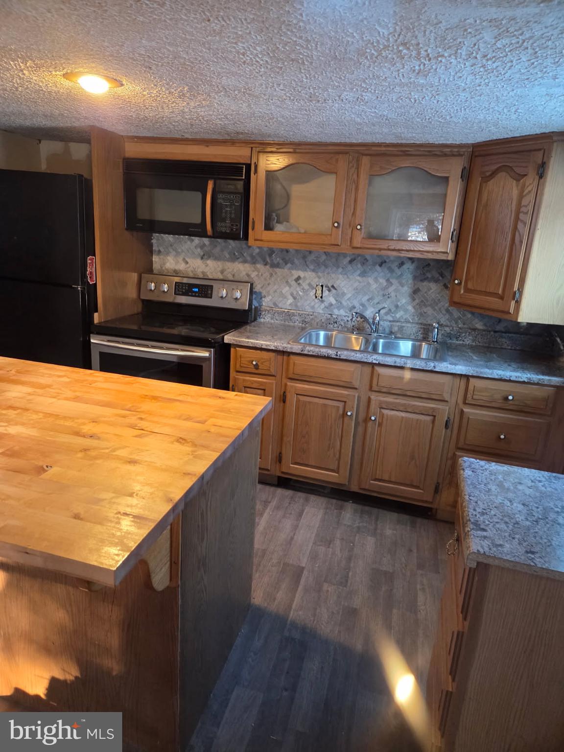 8012 Appleby Road Harrisburg, PA 17112 - Photo 7 of 32 a kitchen with stainless steel appliances wooden cabinets and a counter top space