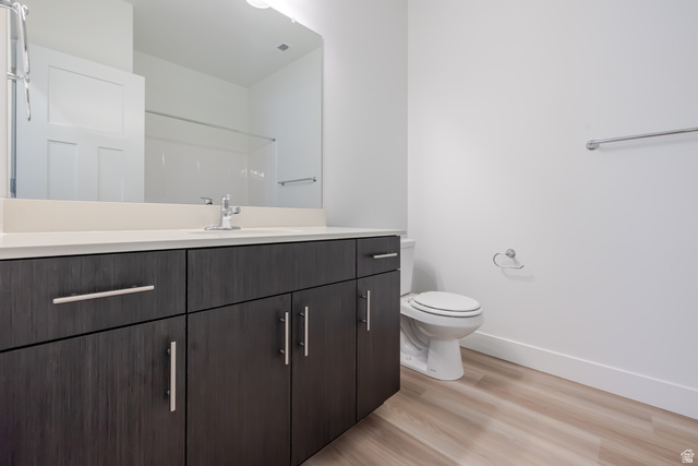 4727 South 690th West, Unit W304 Mapleton, UT 84664 - Photo 6 of 15 Bathroom featuring a vanity with dark wood-finish cabinetry, a light-colored countertop, and a large mirror