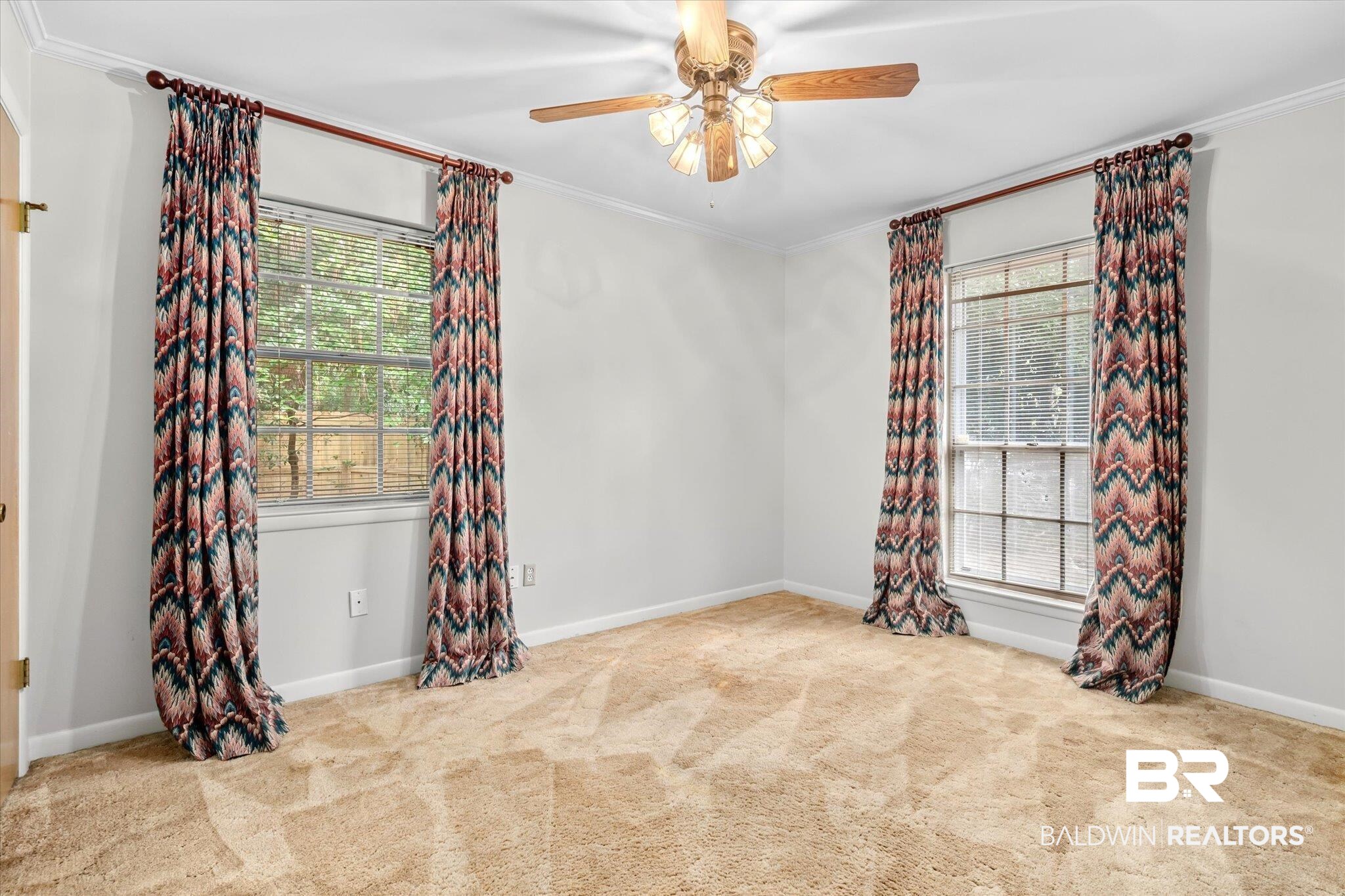 5608 Judson Circle Mobile, AL 36608 - Photo 14 of 20 Empty room with crown molding and a healthy amount of sunlight