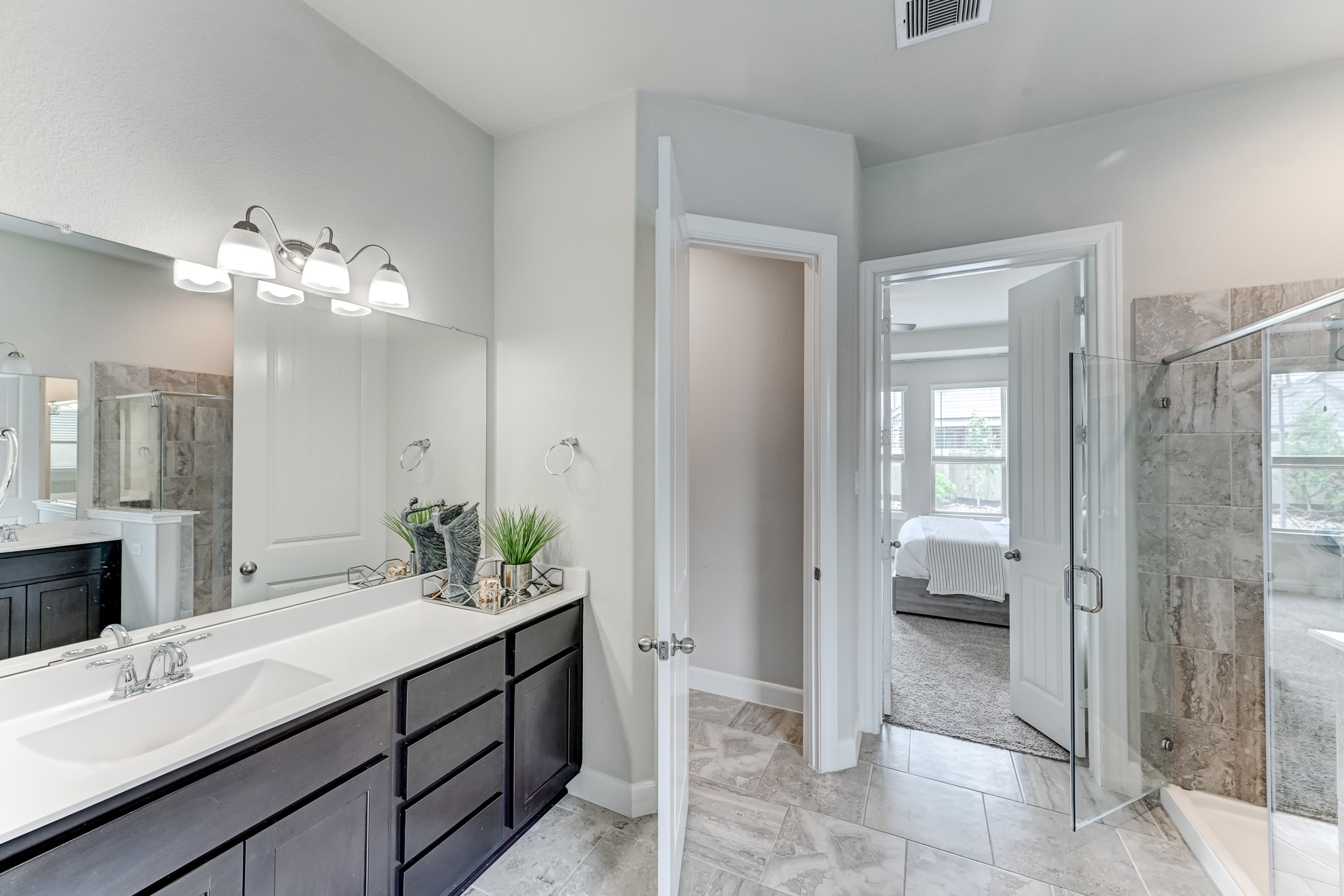 5806 Metaphor Way Rosenberg, TX 77469 - Photo 26 of 50 a spacious bathroom with a shower sink and mirror