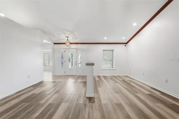 a view of a kitchen with refrigerator and cabinets