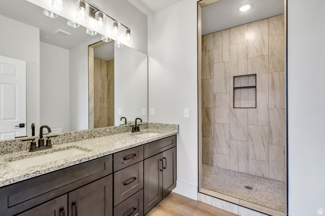547 North Hvn Drive Mapleton, UT 84664 - Photo 14 of 23 Bathroom with double vanity, a walk in shower, and light wood-style floors
