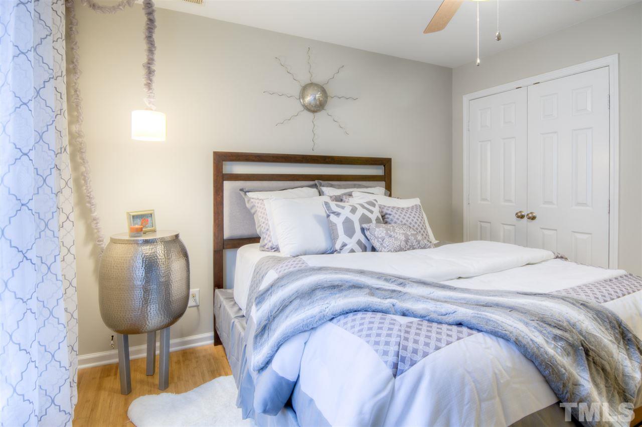 1316 South State Street, Unit C Raleigh, NC 27610 - Photo 3 of 3 a bedroom with a bed and a chandelier