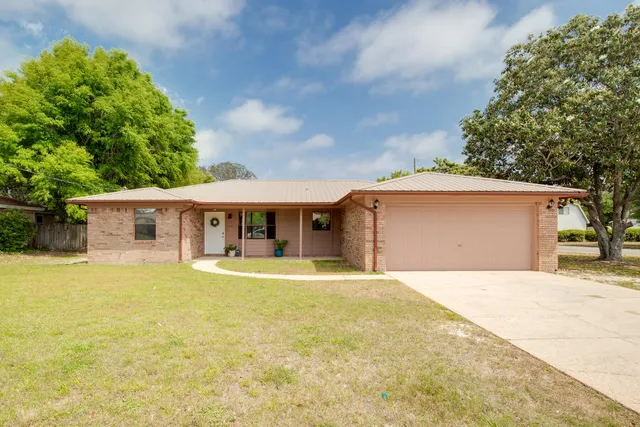 a front view of a house with yard and garage