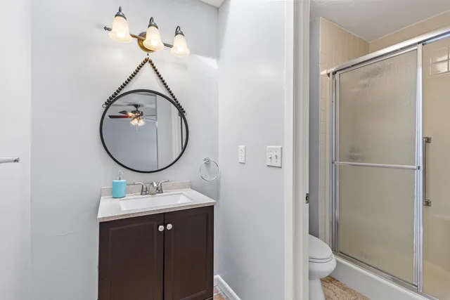 an empty room with a window and ceiling fan