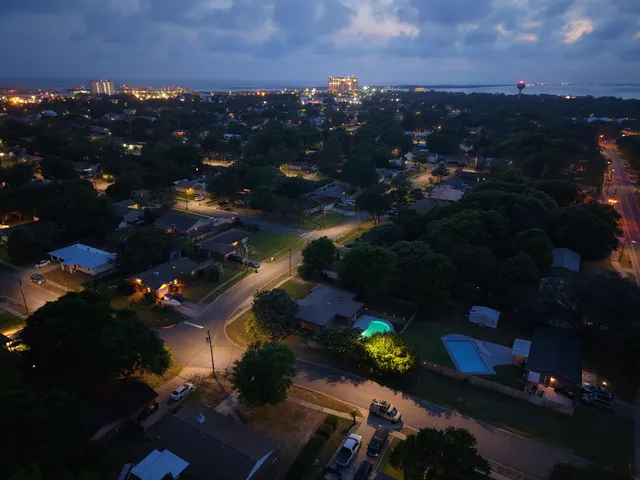 an aerial view of a house with garden space and street view