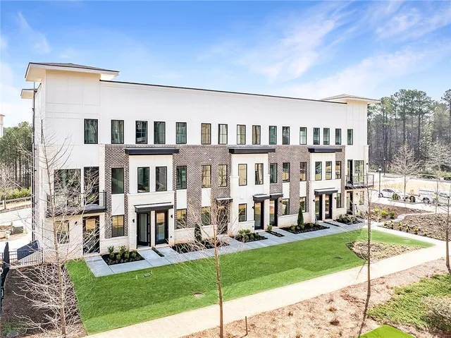 a front view of a building with a garden