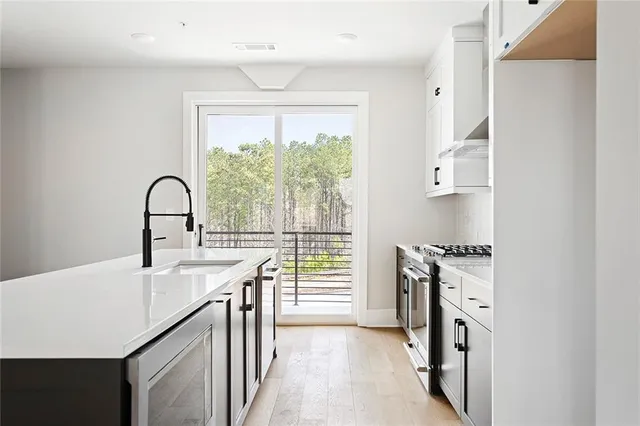 a kitchen with granite countertop a stove and a sink