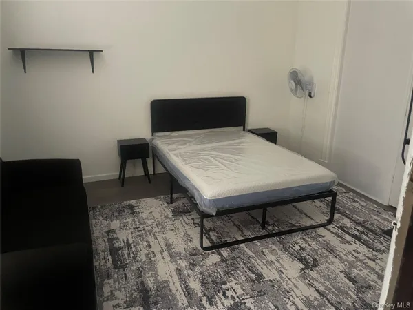 a bed sitting in a bedroom next to a wooden floor