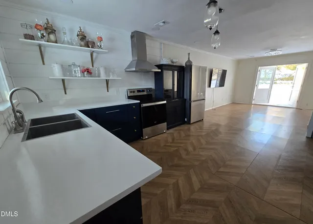 a kitchen with kitchen island a counter space a sink and appliances