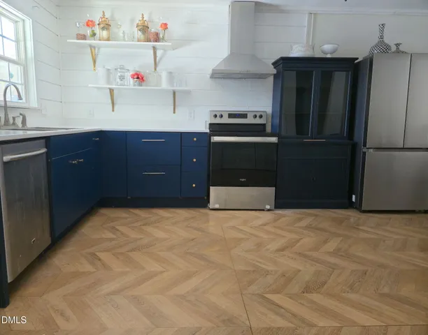 a kitchen with granite countertop a refrigerator and a sink