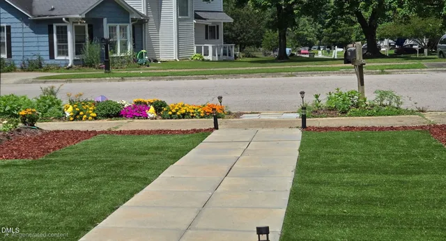 a view of a house with a garden and pathway