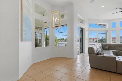 an empty room with windows and fireplace