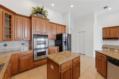 a kitchen with a stove sink and a refrigerator