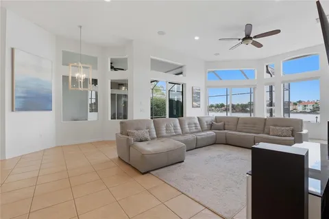 a dining room with furniture a chandelier and wooden floor