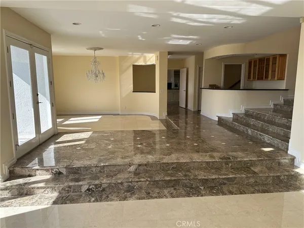 a kitchen with stainless steel appliances granite countertop a stove a refrigerator and a white cabinets