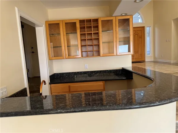 a view of a kitchen with wooden floor and windows