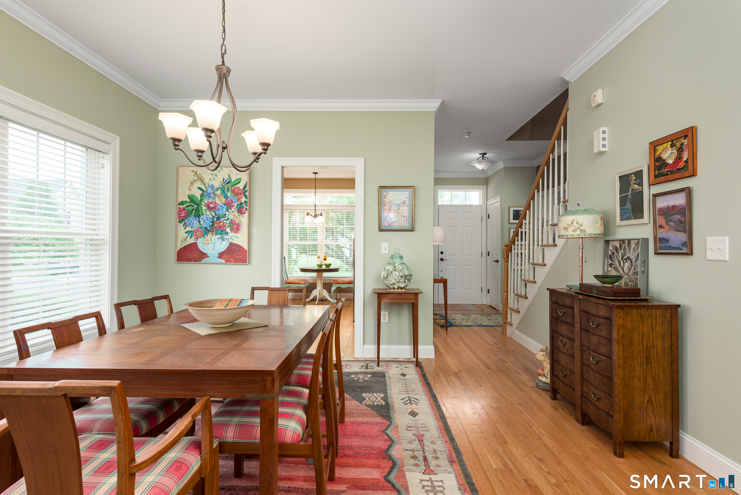 8 Greendale Drive, Unit 8 Suffield, CT 06078 - Photo 20 of 40 a view of a dining room with furniture a chandelier and wooden floor