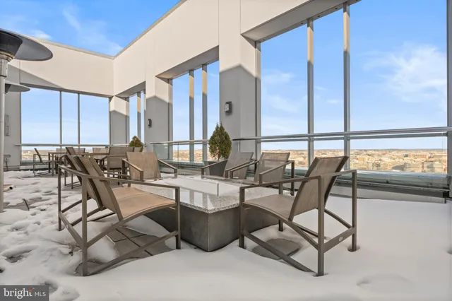 a view of a dining room with furniture and floor to ceiling window