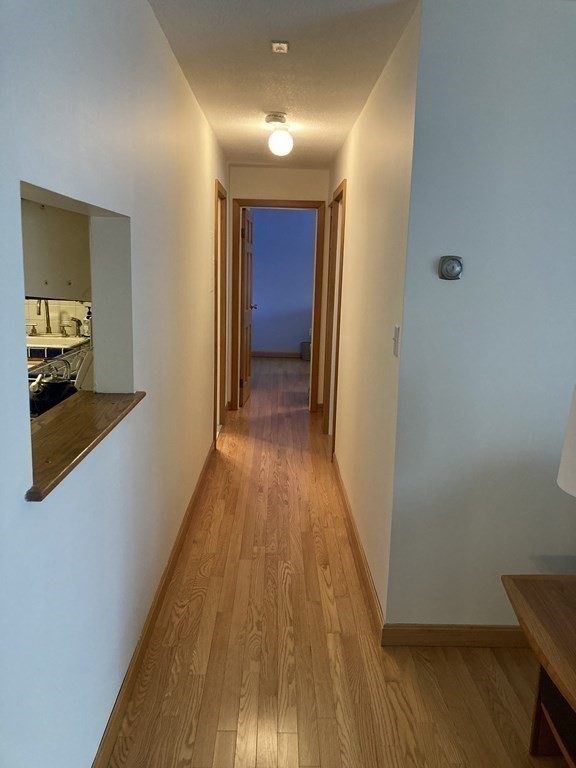 1 Summit Drive, Unit 26 Reading, MA 01867 - Photo 11 of 26 a view of a hallway with wooden floor