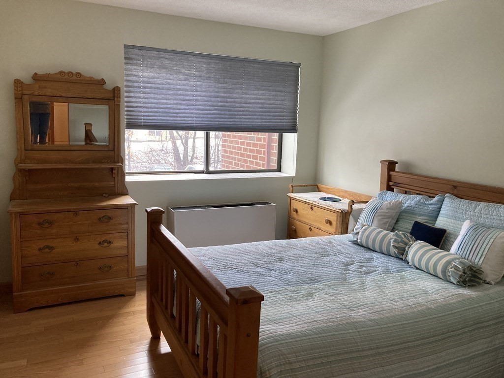 1 Summit Drive, Unit 26 Reading, MA 01867 - Photo 12 of 26 a bedroom with a bed and a dresser