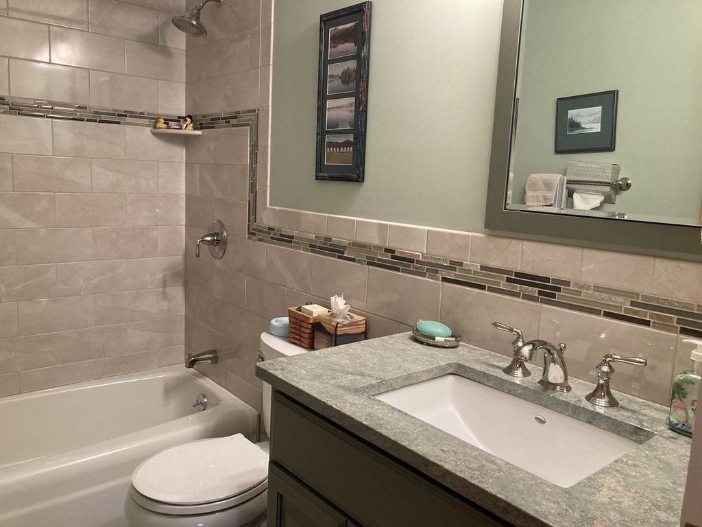 1 Summit Drive, Unit 26 Reading, MA 01867 - Photo 16 of 26 a bathroom with a granite countertop sink toilet and shower