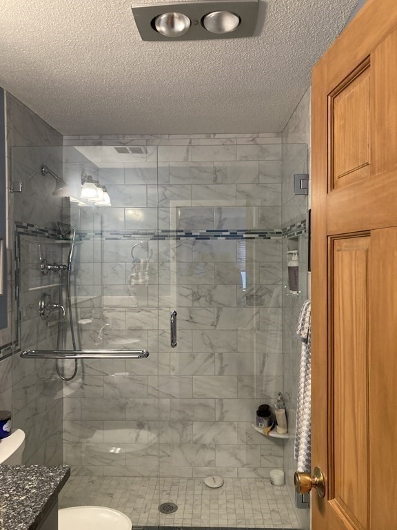 1 Summit Drive, Unit 26 Reading, MA 01867 - Photo 20 of 26 a bathroom with a shower