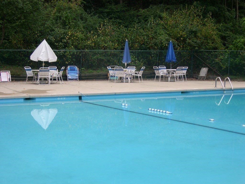 1 Summit Drive, Unit 26 Reading, MA 01867 - Photo 26 of 26 a view of a table and chairs in patio of the house