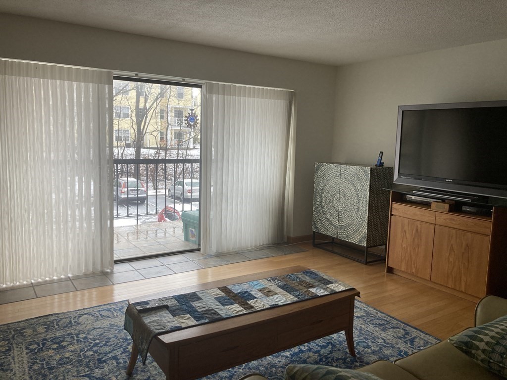 1 Summit Drive, Unit 26 Reading, MA 01867 - Photo 3 of 26 a living room with furniture and a flat screen tv