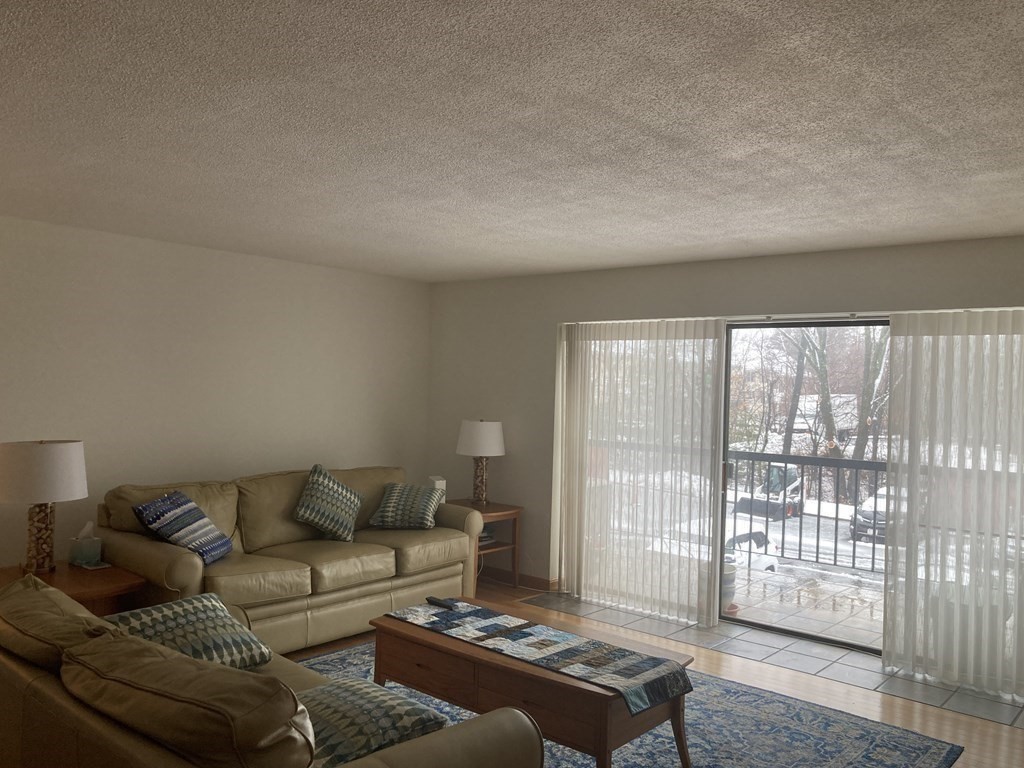 1 Summit Drive, Unit 26 Reading, MA 01867 - Photo 4 of 26 a living room with furniture and a window