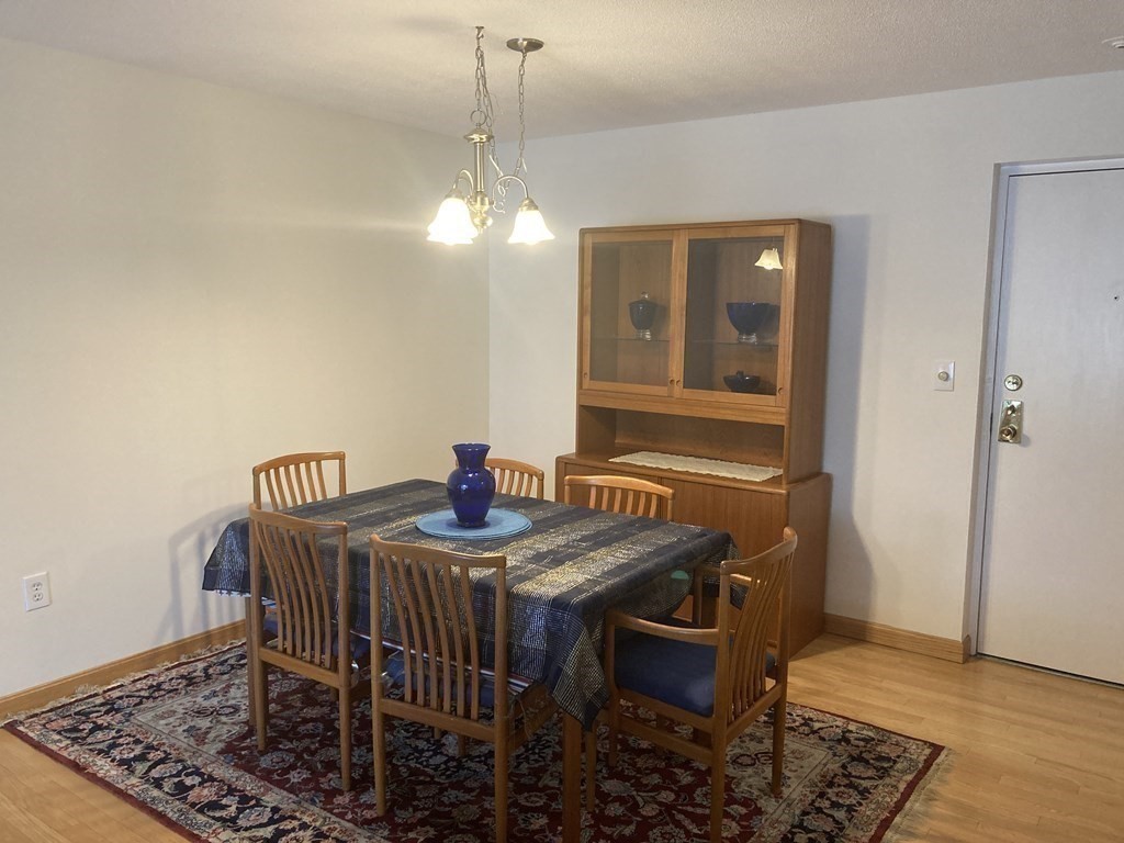 1 Summit Drive, Unit 26 Reading, MA 01867 - Photo 5 of 26 a view of a dining room with furniture and wooden floor
