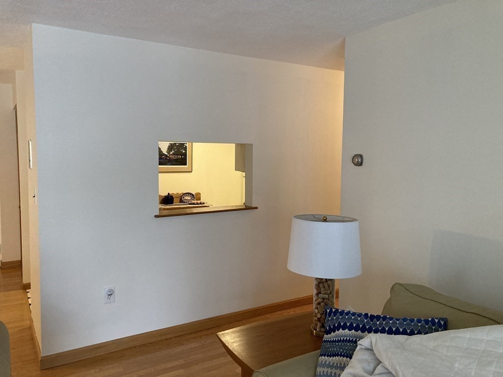 1 Summit Drive, Unit 26 Reading, MA 01867 - Photo 10 of 26 a room with a table and a lamp