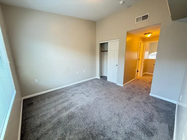 an empty room with a bathroom and sink