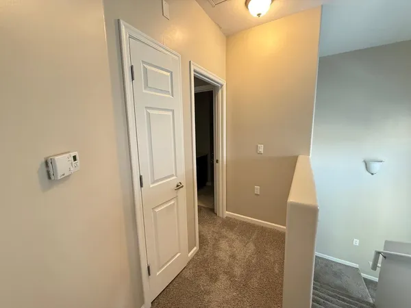 a view of a hallway with wooden shelves